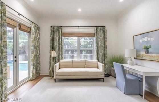 Office space with wood finished floors, crown molding, and recessed lighting