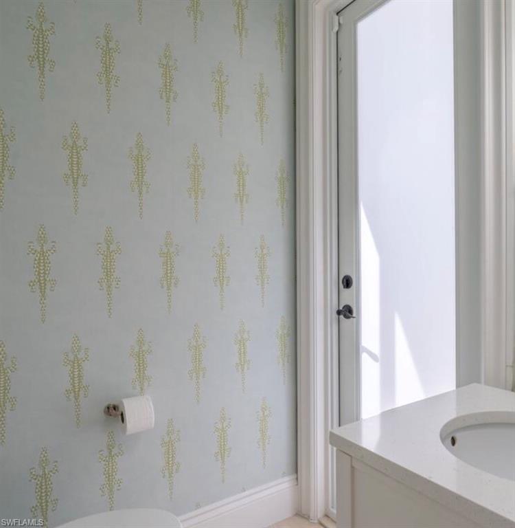 Bathroom featuring vanity and baseboards
