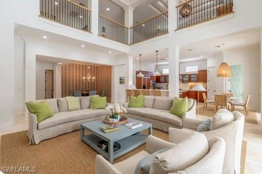 Living room featuring a chandelier and a high ceiling