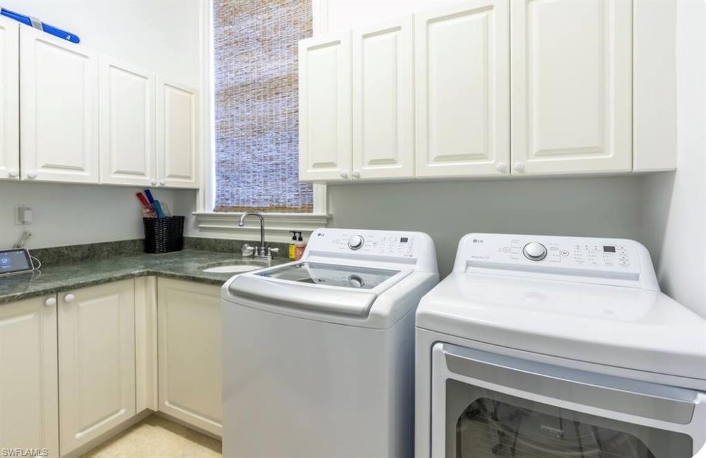 Laundry area with washer and clothes dryer and cabinet space