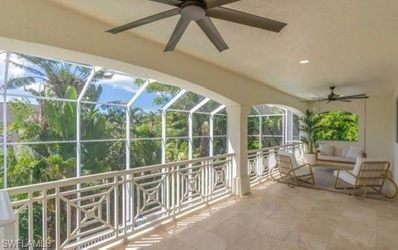 Unfurnished sunroom featuring ceiling fan