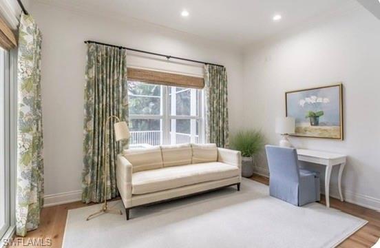 Sitting room with wood finished floors and recessed lighting