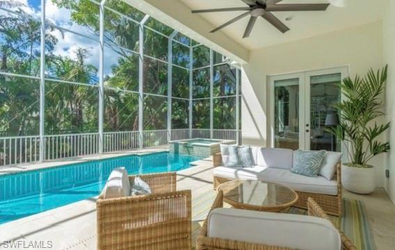 Sunroom / solarium with french doors, a jacuzzi, a patio, a pool, and outdoor lounge area