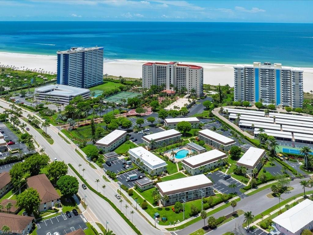 Aerial overview of a coastal community featuring multiple residential buildings