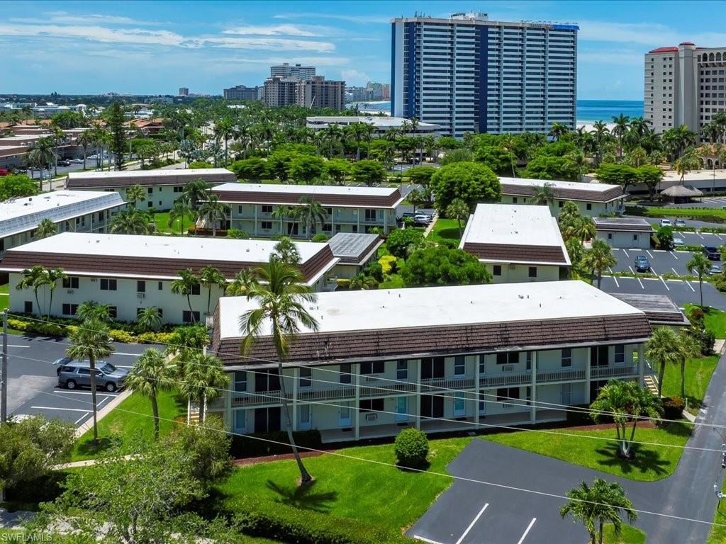 Multi-story buildings featuring white exteriors and brown roofs