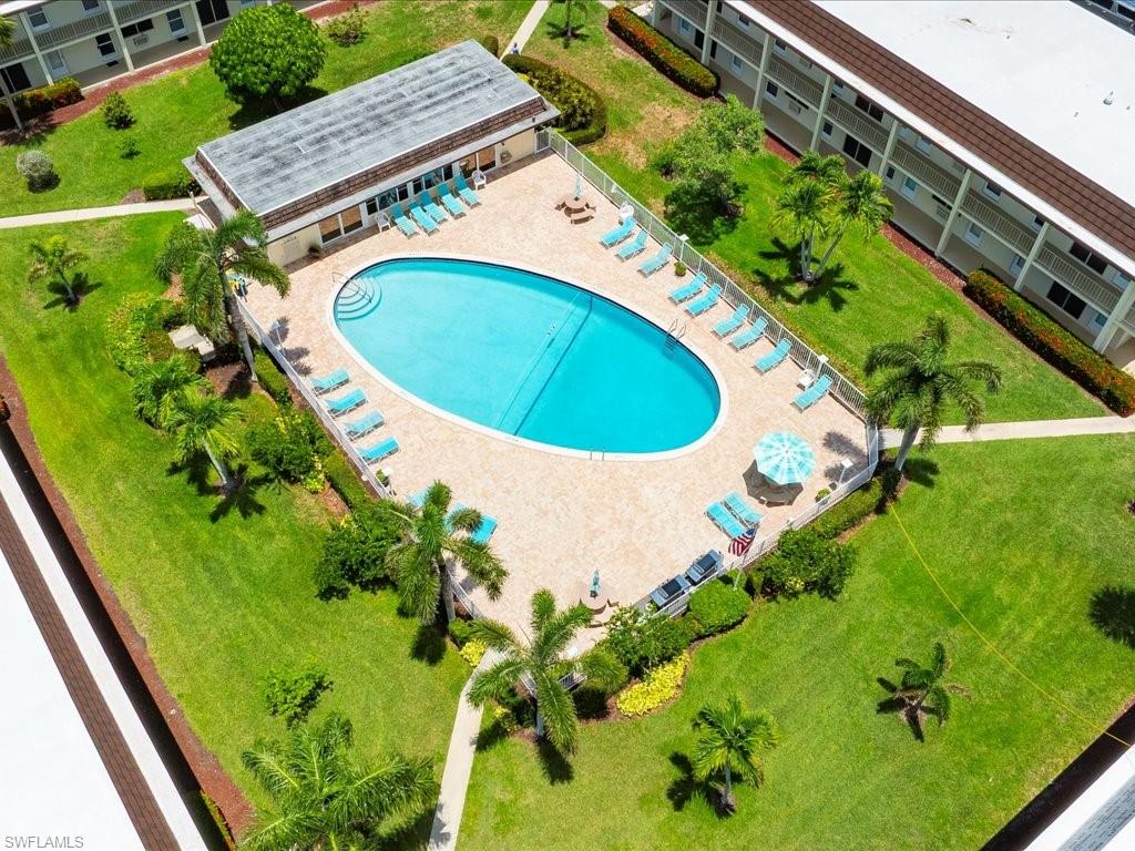 Oval-shaped swimming pool with surrounding paver deck