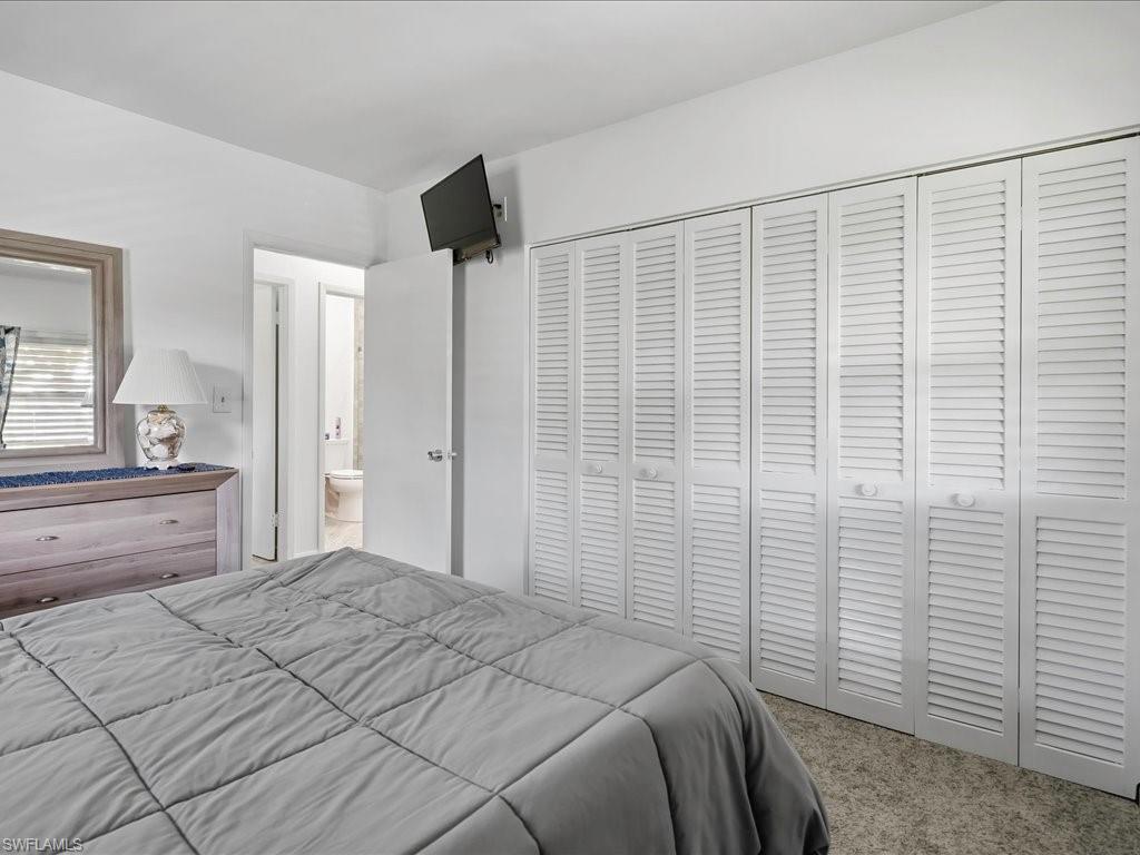 Wall-to-wall louvered closet doors spanning the room's width