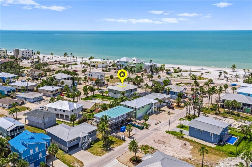 West Beach View - Birds eye view of property featuring a view of the beach, a water view, and a residential view - VIRTUAL EDITED EXTERIOR IMAGE