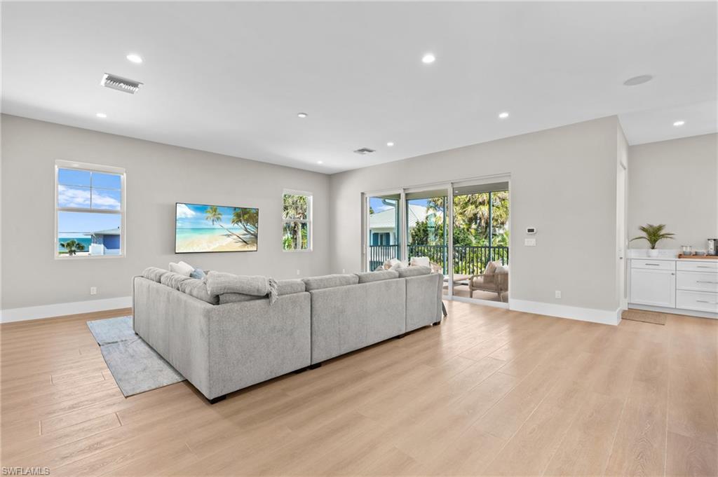 Invite your Family, Lots of Room  - Living room with visible vents, light wood finished floors, and baseboards. virtually edited photo