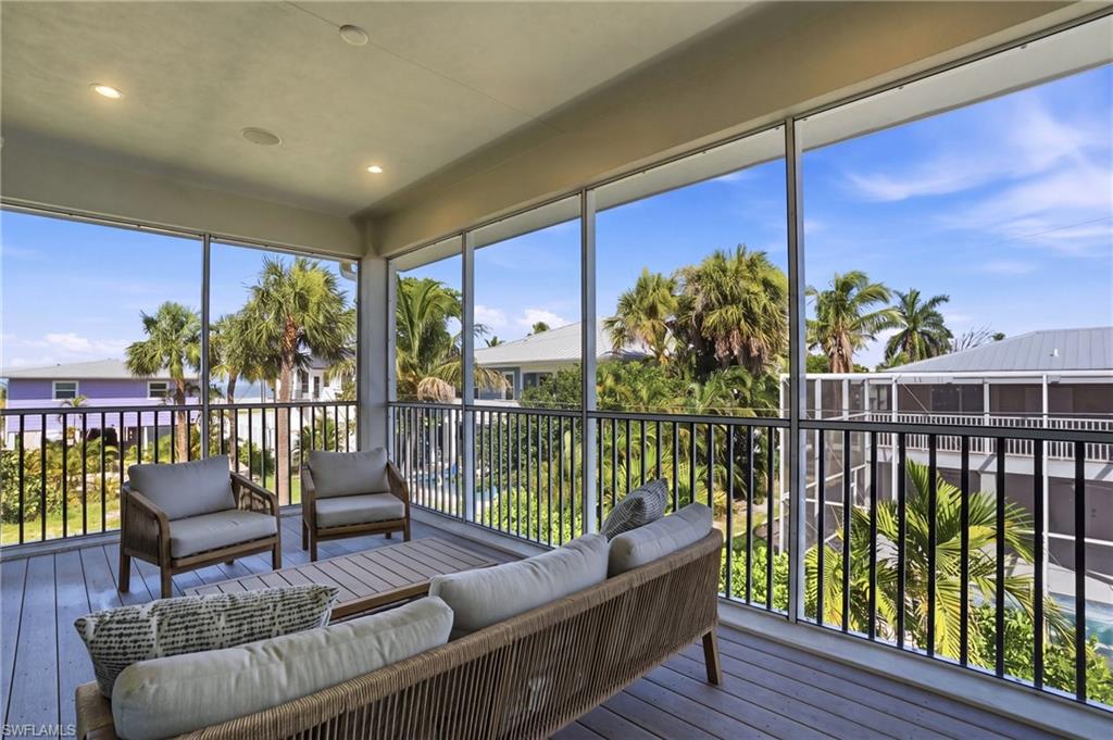 Screened in balcony with outdoor lounge area. virtually edited photo