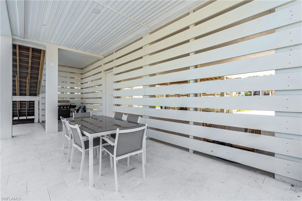 View of patio featuring outdoor dining area. virtually edited photo