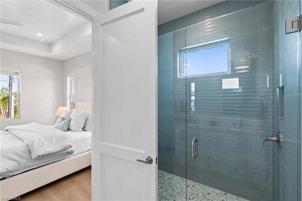 Bathroom with plenty of natural light, ensuite bath, recessed lighting, and a tile shower. virtually edited photo