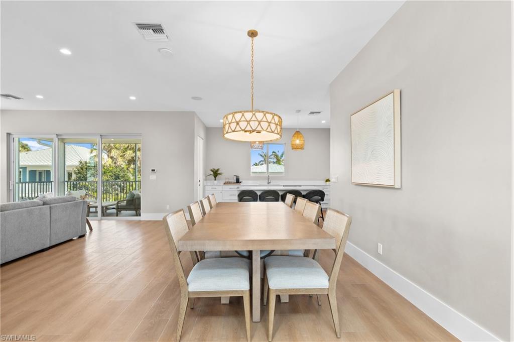 Dining space featuring baseboards, light wood-style flooring, visible vents, and recessed lighting. virtually edited photo