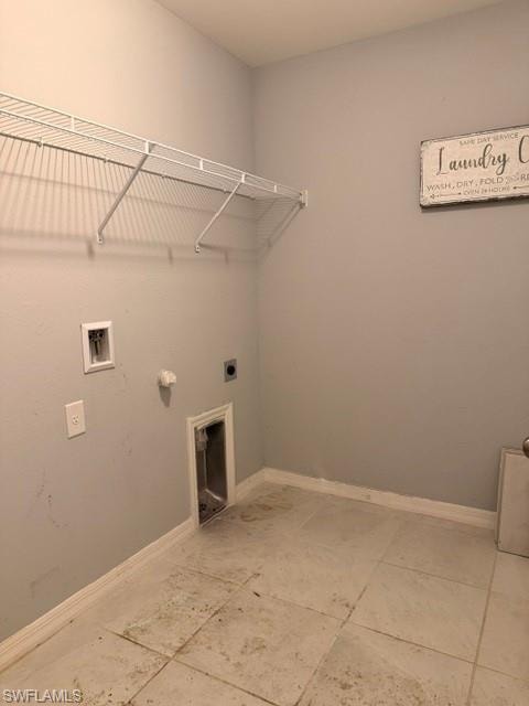 Laundry area featuring light gray walls, white baseboards, and square tile flooring