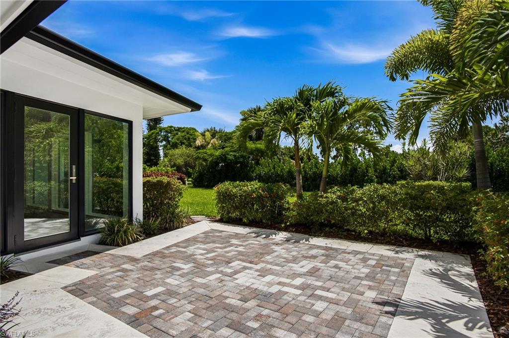 Step outside to your private patio, ideal for AL FRESCO DINING, overlooking a LARGE & BEAUTIFULLY LANDSCAPED backyard designed for EXCEPTIONAL PRIVACY from neighboring homes and the community pool beyond.