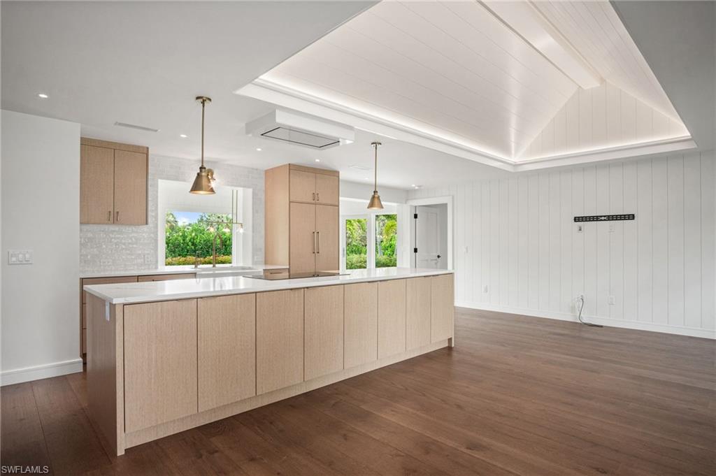 METICULOUS CRAFTSMANSHIP & HIGH-END LUXURY FINISHES including WIDE-PLANK FRENCH OAK FLOORING, shiplap accent walls, soaring vaulted ceilings with cove lighting, and dramatic FLOOR-TO-CEILING WINDOWS that bathe the home in NATURAL LIGHT while framing TRANQUIL VIEWS of the SURROUNDING GREENERY with COVETED SOUTH REAR EXPOSURE!