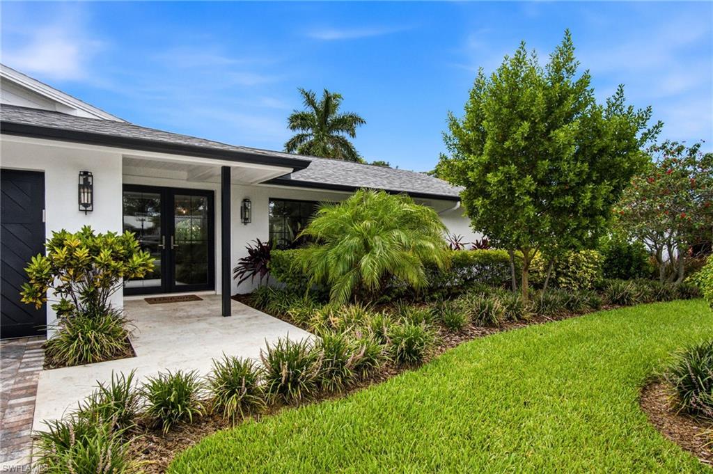NEW PAVER DRIVEWAY, custom impact-rated garage door, exterior doors & windows.
