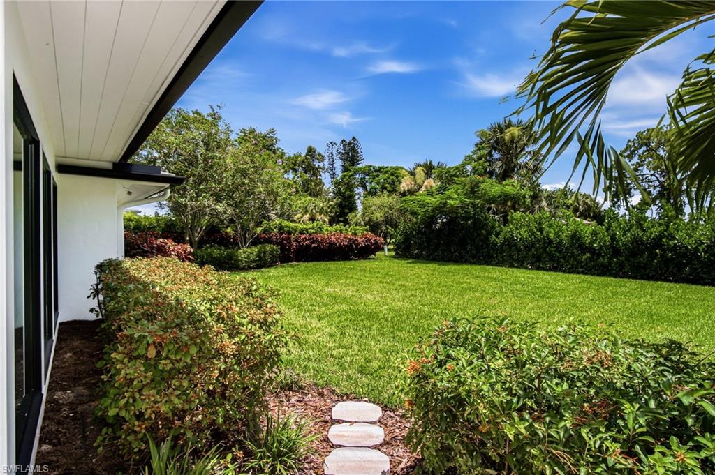 Spacious & lushly landscaped back yard with tons of room for a private pool.