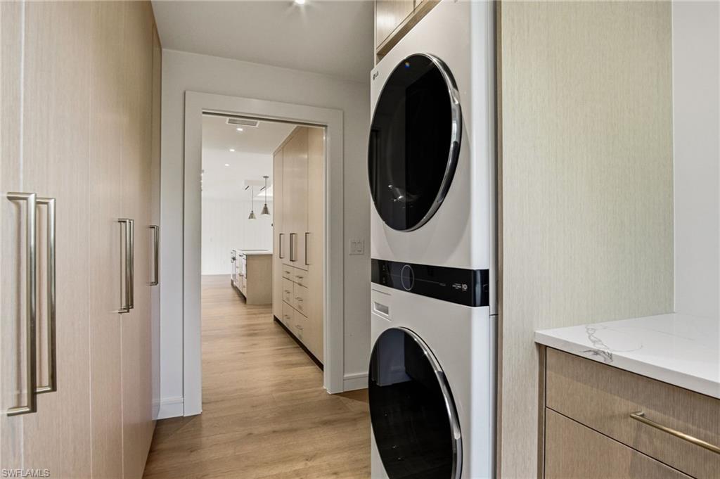 Spacious laundry room with a new LG washer and dryer plus floor-to-ceiling custom cabinetry.