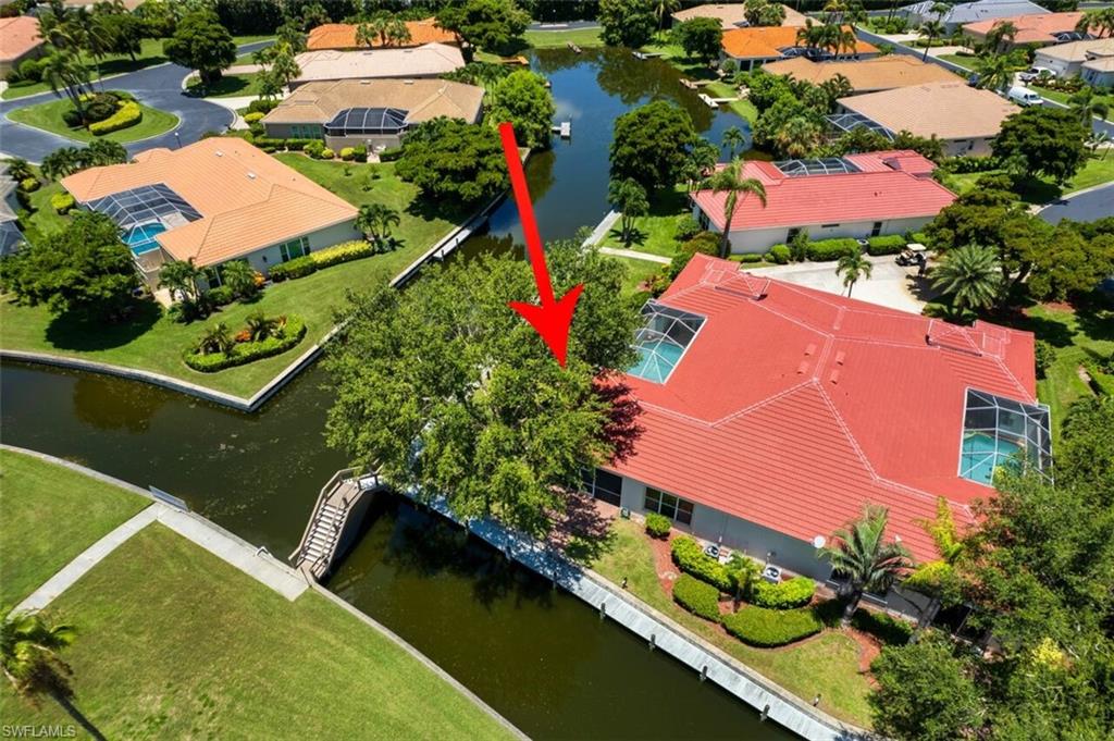 Birds eye view of property with a water view