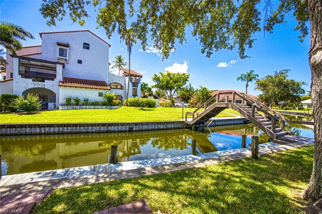 Dock area featuring a water view and a yard