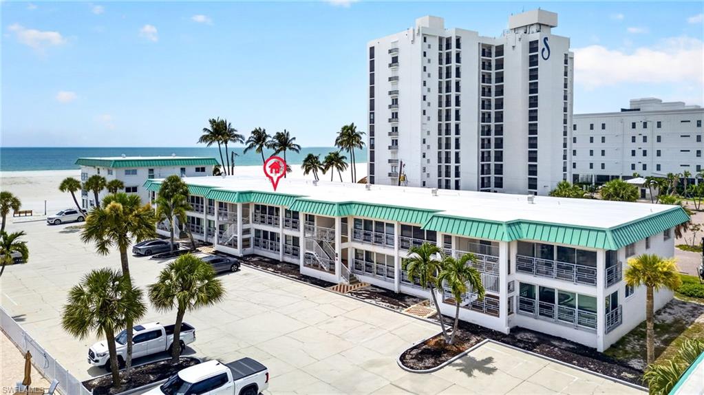 Two-story building featuring multiple units with individual balconies/patios