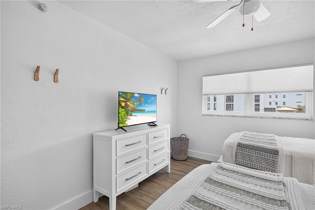 White interior with textured walls and wood-finish flooring