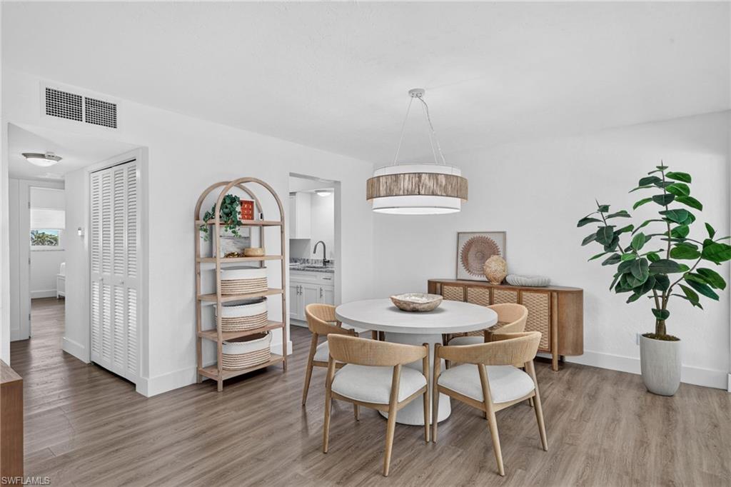 Bright dining area featuring wood-finish flooring and white baseboards