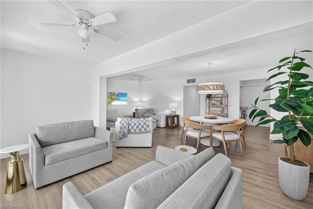 Bright living and dining areas featuring wood-finish flooring