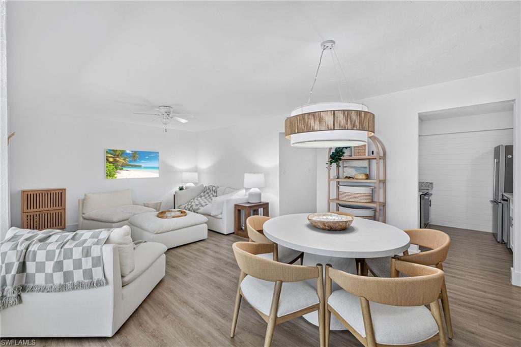 Open-concept living area with wood-finish flooring, a contemporary ceiling fan, and recessed lighting