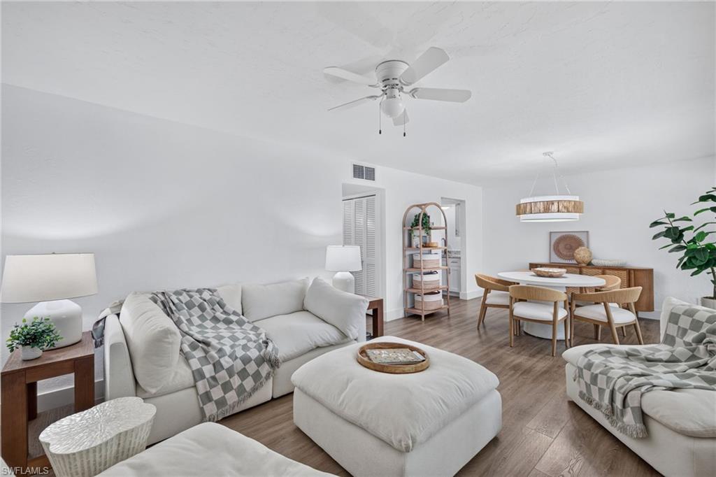 Open-concept living and dining area featuring wood-finish flooring, recessed lighting, and a ceiling fan