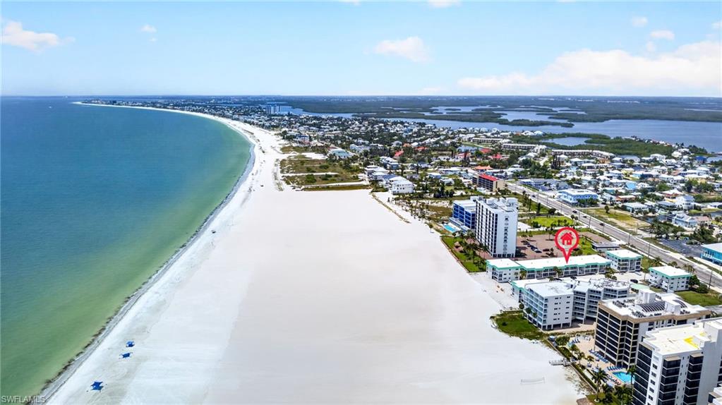 Expansive white sand beach bordering turquoise waters