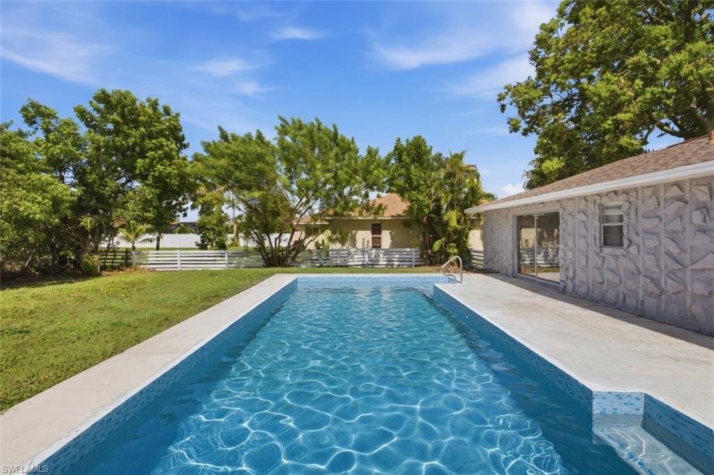 Rectangular swimming pool with integrated steps and a surrounding concrete deck