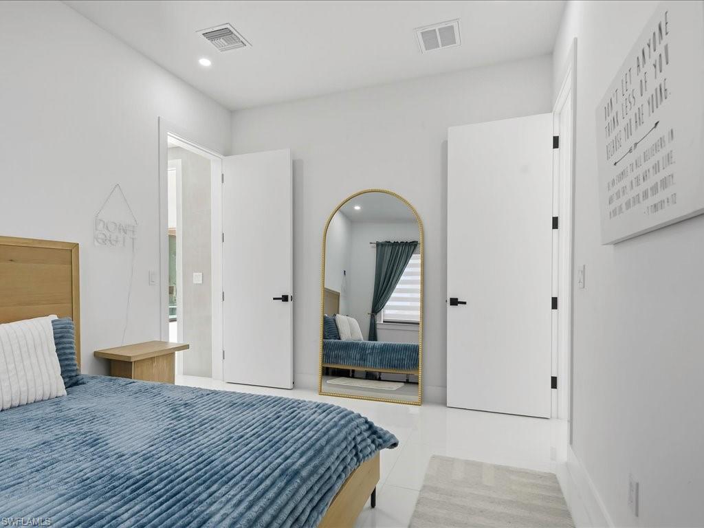 Bright interior space featuring white walls and tile flooring