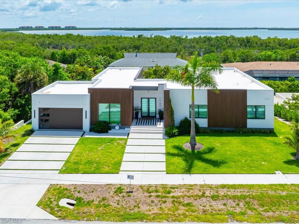 Modern architectural exterior featuring white stucco and wood-finish paneling