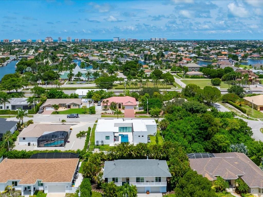 Expansive aerial overview of a coastal residential area featuring numerous properties