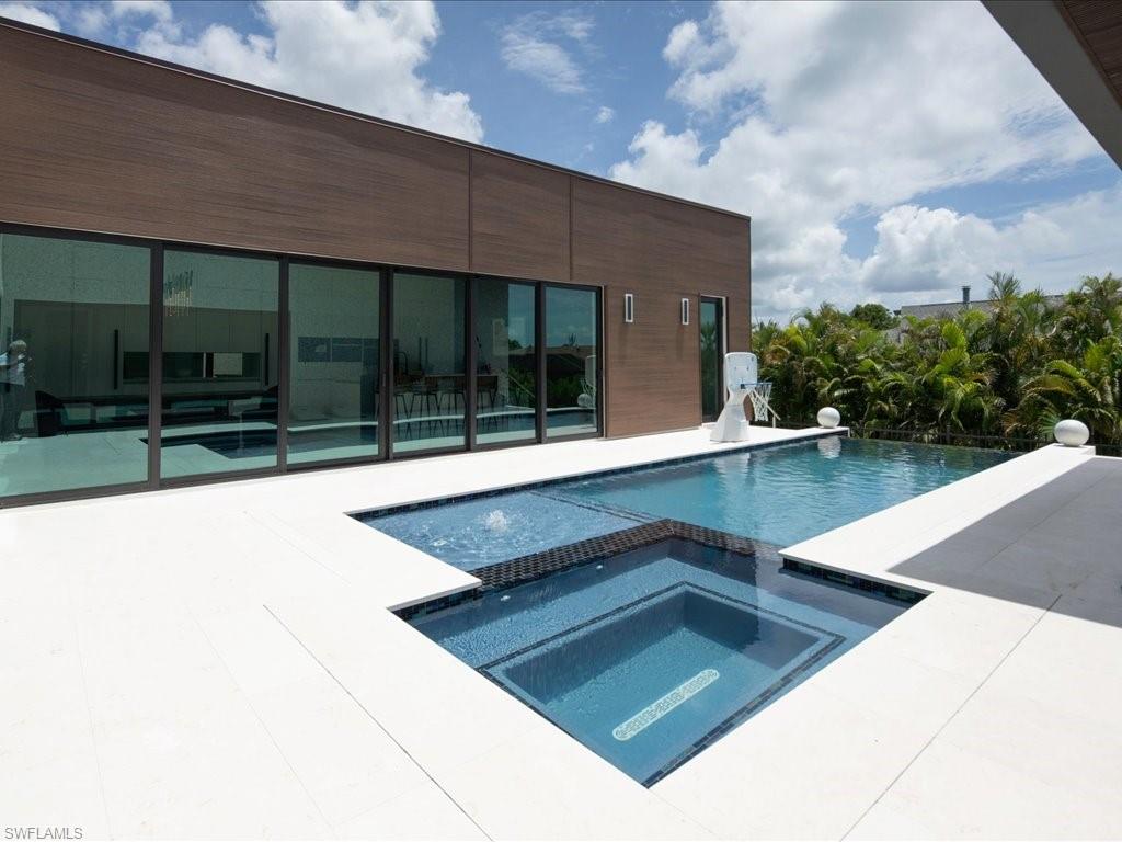 Modern exterior featuring a dark wood-finish facade and expansive glass sliders