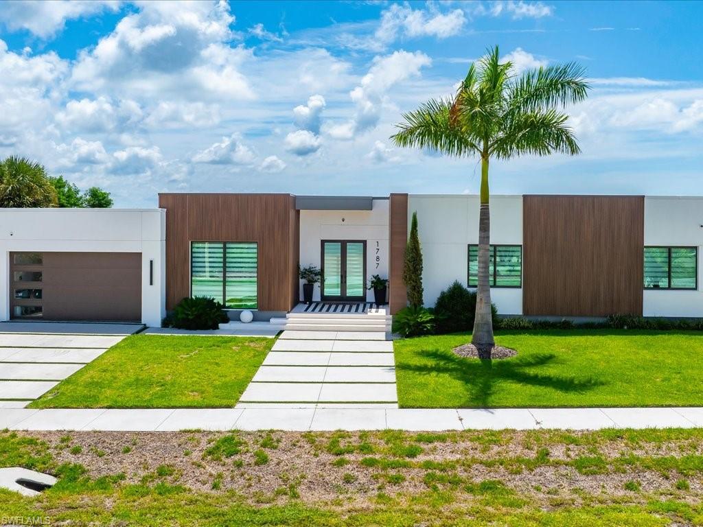 Contemporary exterior featuring white stucco and wood-finish accent panels