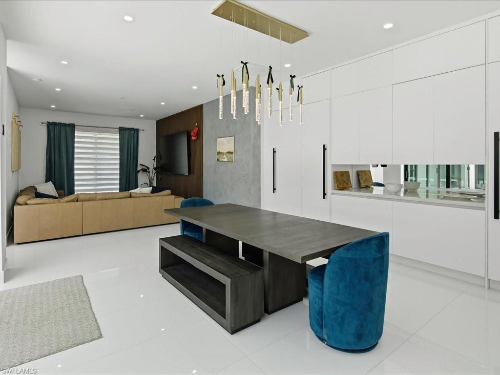 Open-concept living space featuring high-gloss white tile flooring
