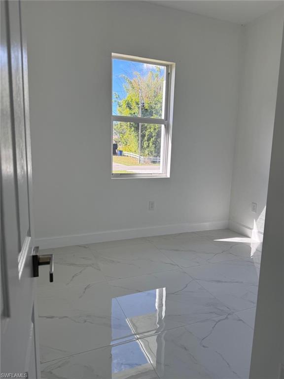 Empty room featuring light marble finish flooring