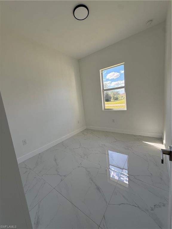 Empty room with light marble finish floors and baseboards