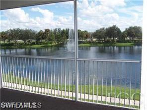Screened balcony offering lakefront scenery with a fountain feature