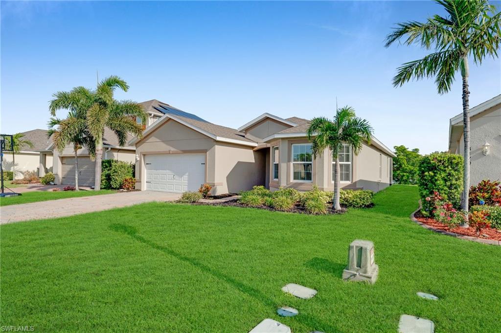 Single-story stucco exterior with an attached garage, bay window, and a concrete driveway
