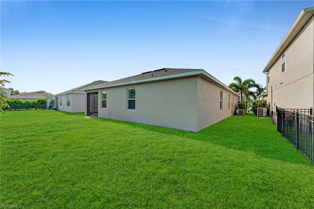 Expansive green lawn with a screened patio entry