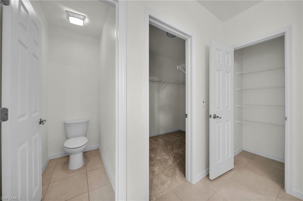 Powder room featuring a standard toilet and recessed lighting