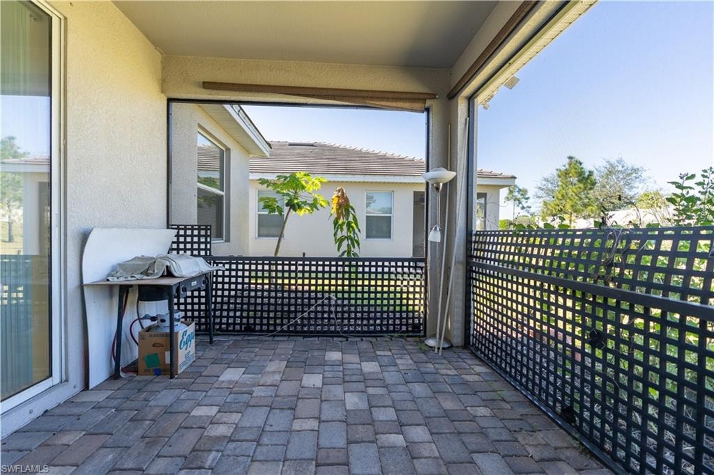 Covered patio featuring paver flooring