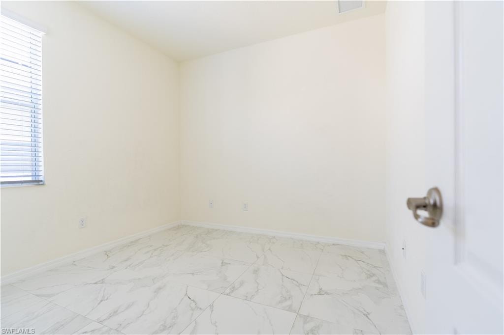 Room featuring white walls and white baseboards