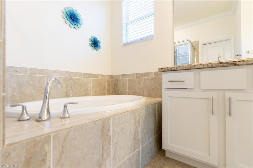 Soaking tub with chrome fixtures and surrounding tilework