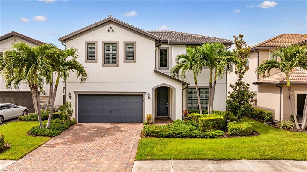 Contemporary white stucco exterior with a dark tile roof