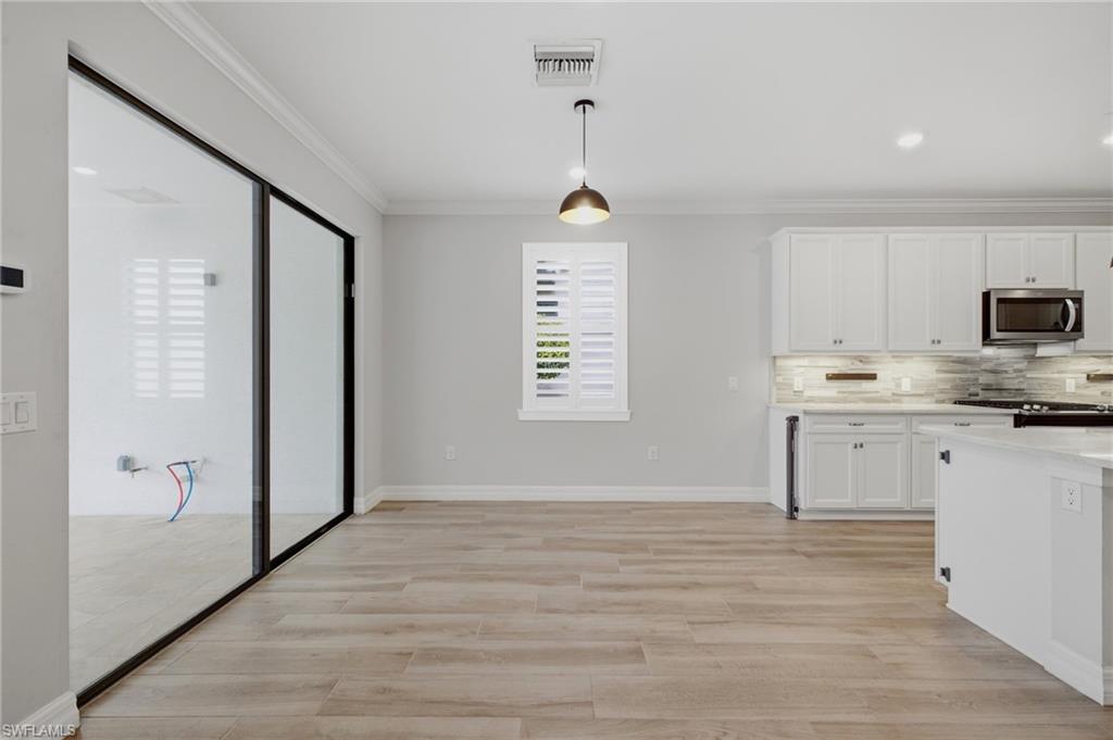 Open concept living space featuring wood-finish flooring and a contemporary kitchen